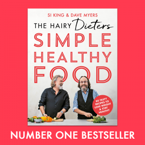 Book cover of Simple Healthy Food by the Hairy Bikers placed on a salmon pink background.